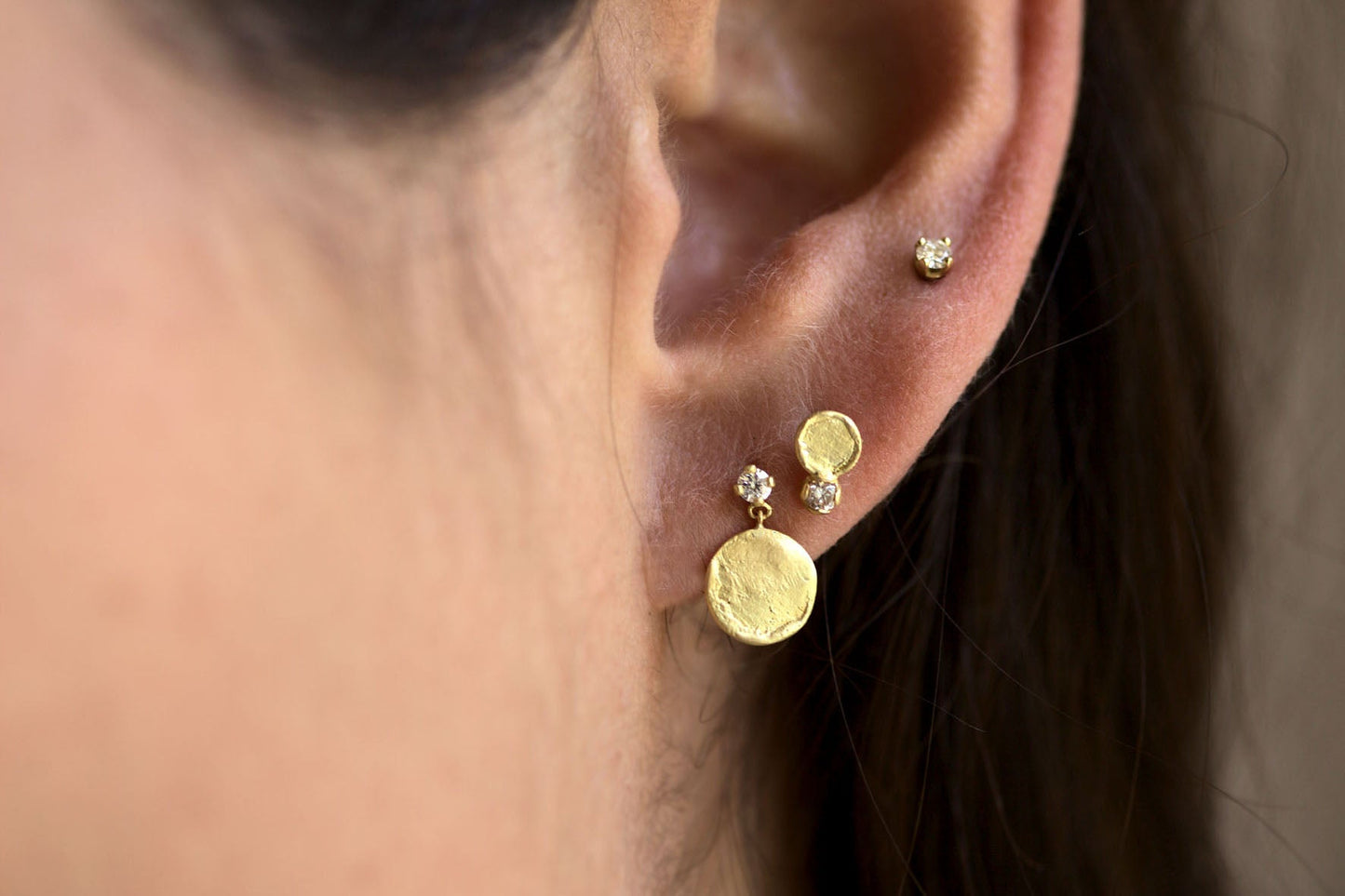 Diamond and textured disc collection in recycled gold.
